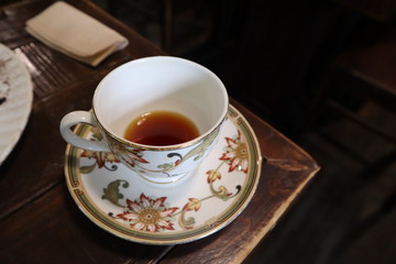 Coffee cup on a wooden table with vintage interior in a cafe located in south Korea.