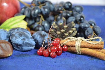 Autumn harvest, grapes, autumn fallen leaves, apples, plums, cinnamon, anise. wild grapes in autumn in the rain