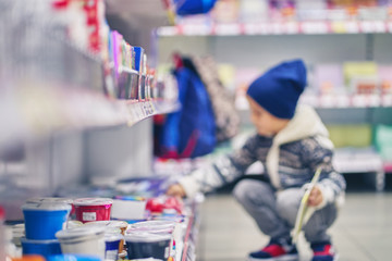 blurry image of a little boy. school goods store