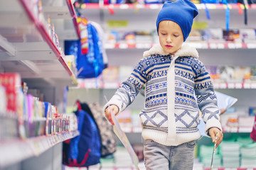 schoolboy in a stationery store