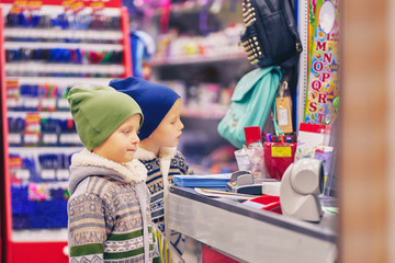 Fototapeta na wymiar two boys at the checkout. sale of school supplies.