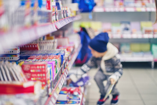 blurry image of a little boy. shopping to school. stationery department