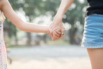 Close up Daughter hand holding with her Mother , feel comforted  and affectionate, happy family time