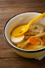 Hot soup with noodles and white meat, food close-up