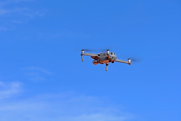 Fototapeta na wymiar Black drone quadcopter flying on the air for take a photo and video with blue sky background.
