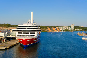 Sea port on the Aurajoki River, with a passenger ferry standing at the pier. Turku, Finland.