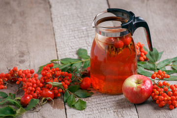 Hot tea from rosehip berries and fruit in transparent glasses and honey on a wooden table. Harvesting, autumn fall winter hot warming tea, immunity beverage