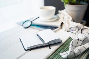 workplace with a notebook and a cup of coffee