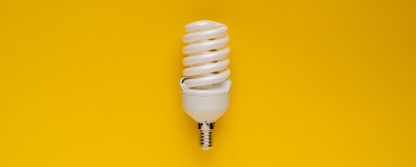 classic energy-saving white lamp, with efficient power use, isolated on color background