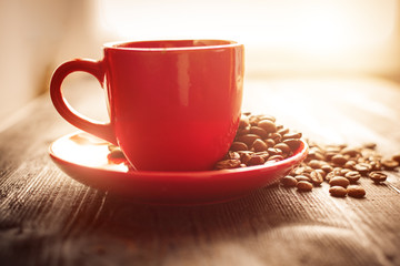 Red coffee cup on wooden desk - coffee mood