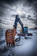 Old excavator in winter
