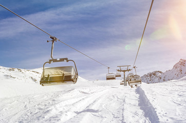 Chairlift in a ski resort in winter with scenic lens flare