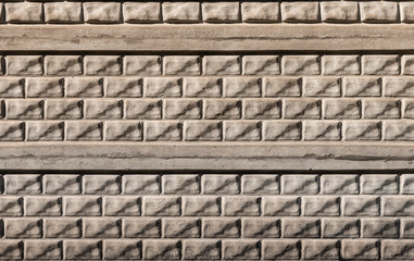 Gray old solid dirty spotty wall made of unusual brick and concrete slabs. Abstract texture...