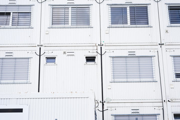 Containers officers in white color with gray windows, temporary workspace for supporting workers in a construction environment.