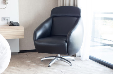 Leather chair in a room, bright light from the window
