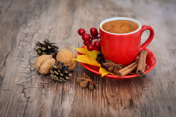 Autumn coffee. Concept of morning coffee. Morning autumn coffee background with leaves, cones and nuts on a wood