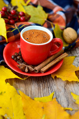 Autumn coffee. Concept of morning coffee. Morning autumn coffee background with leaves, cones and nuts on a wood