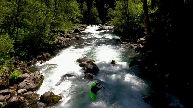 Aerial view of whitewater kayaker running class IV rapids on the Mill Creek section of the Rogue River in southern Oregon.