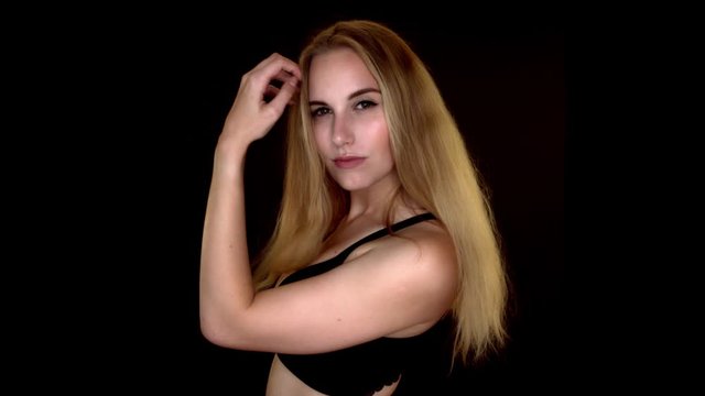 Attractive blond girl looks seductively at the camera. Slowmotion