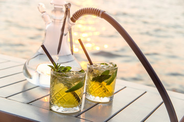 Serving mojito and hookah in an outdoor cafe as a summer vacation