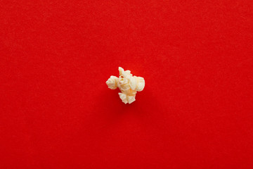 top view of sweet popcorn on red background