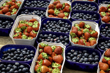 Blueberries and strawberries in market