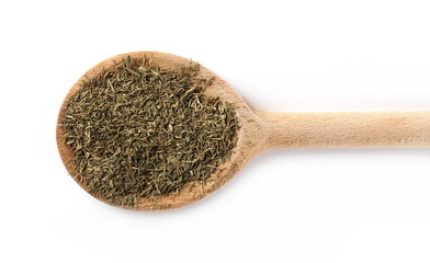 Pile of dry dill with wooden spoon isolated on white background, top view