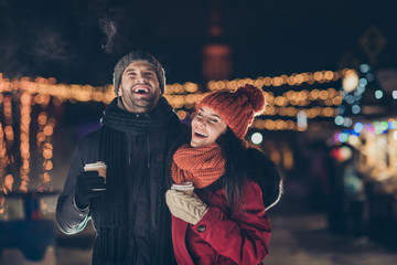 Photo of two people with hot beverage in hands spending x-mas evening together telling humorous...