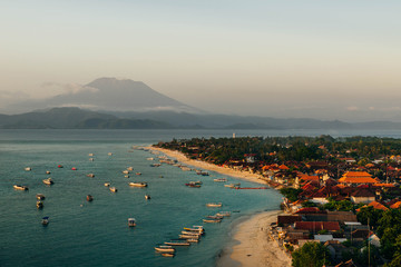 Panoramic view of the northern coast of the island of Lembongan and Jungutbatu village. Gungung Agung, the active volcano on the island of Bali is visible in the background.