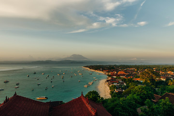 Panoramic view of the northern coast of the island of Lembongan and Jungutbatu village. Gungung Agung, the active volcano on the island of Bali is visible in the background.