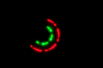 Fototapeta premium Green and red semicircle formed by the rapid movement of the luminous spinner