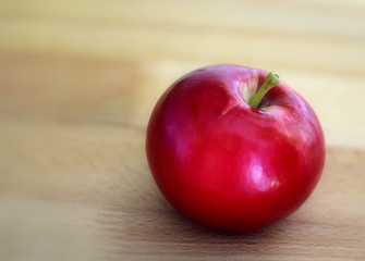 red apple on wooden table