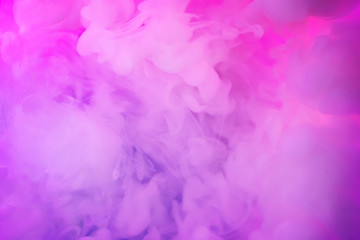 Paints dissolved in water with a beautiful spectacular blur. Trending neon purple colors. Bright amazing abstract background. Smoke effect.