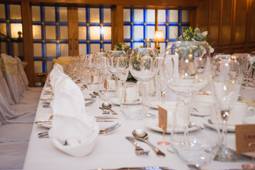 Tables set for an event party or wedding reception. luxury elegant table setting dinner in a restaurant. glasses and dishes.