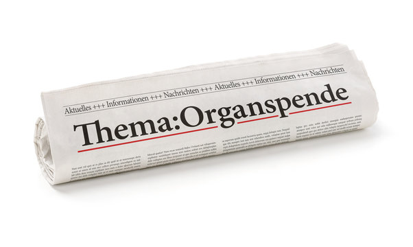 Zeitungsrolle mit der &Uuml;berschrift Organspende