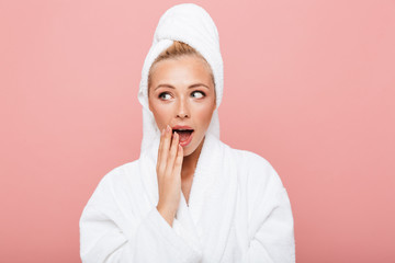 Arttractive young woman wearing bathrobe and towel