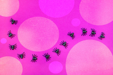 Background consisting of halloween spiders and violet background with different shades of violet circles.