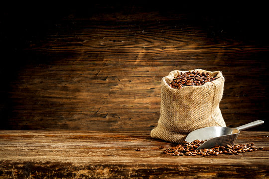 Fresh coffee grains in brown sack and free space for your decoration. 