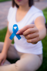 The girl holding a black ribbon, symbol of cancer. Colon awareness month.
