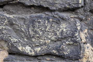 Antique masonry made of rough stone. Textures.