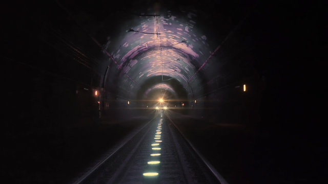 Bright Train Lights Coming Towards Camera In A Dark Railway Tunnel