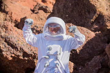 Astronaut spaceman Standing on the Rocky Mountain of the Alien Red   Planet/ Mars. First Manned Mission on Mars. Space Exploration,   Colonization.