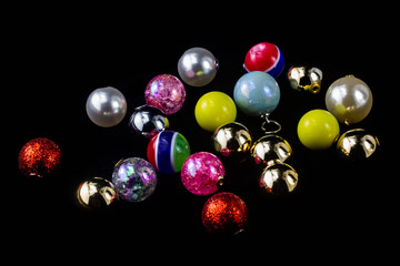 A variety of Christmas balls on a black background