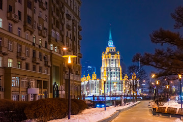Fototapeta na wymiar Evening Moscow. Capital of Russia. Winter in Russia. Deserted street with lanterns. High-rise building on Kotelnicheskaya embankment. Architecture of Moscow. Tall building. Symbol of Moscow.