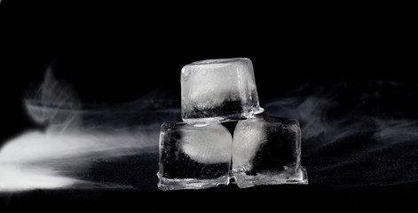 Three pieces of ice with smoke on a black background 3