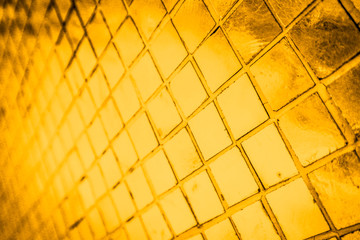 Beautiful closeup textures abstract color dark yellow and gold tiles granite and gold glass pattern wall and background and art