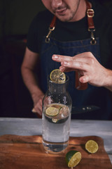 Young chef in kitchen preparing juice. Food concept.