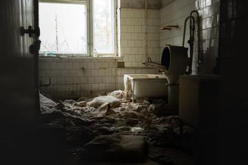 Fototapeta na wymiar Old laundry room of abandoned hospital
