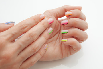Close-up. Multicolored modern manicure, nail design. Summer mood, on white background.