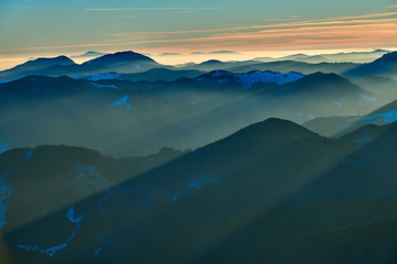 Obraz premium Aerial Landscape view from Ceahlău Mountains National Park at sunset in winter season,Sunset in Ceahlau Mountains